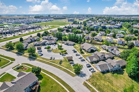 A suburban neighborhood with houses and parked cars.