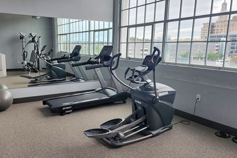 A gym with treadmills and elliptical machines.