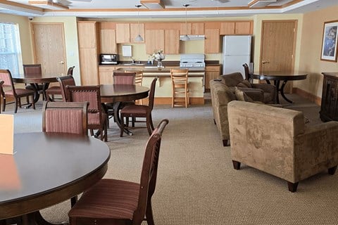 A kitchen with a table and chairs in the foreground.