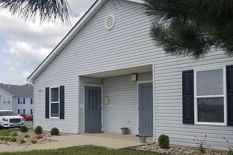 A house with a grey door and windows.