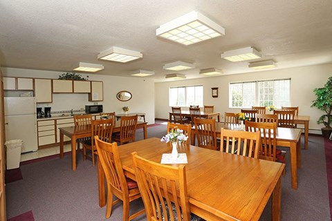 a dining room with wooden tables and chairs