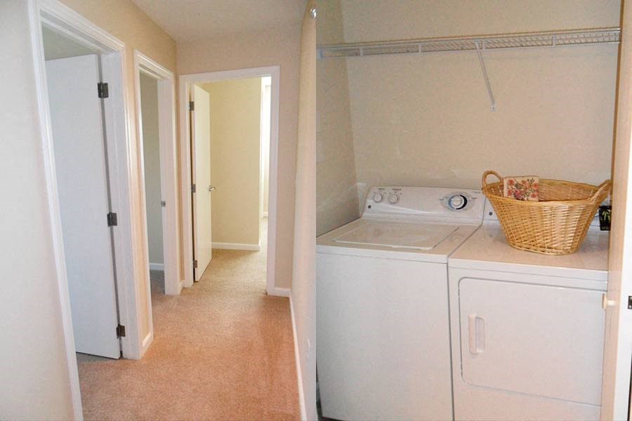 a laundry room with a washing machine and a basket
