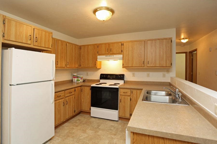 a kitchen with a stove refrigerator and a sink