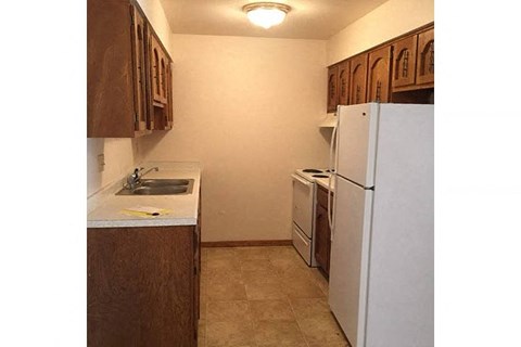 a small kitchen with a refrigerator and a sink