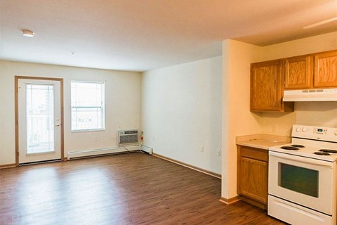 A kitchen with a stove and a window.