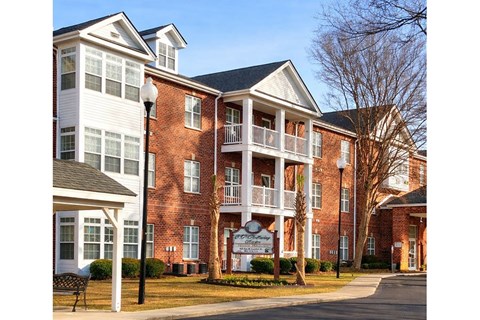 A large brick building with a sign in front of it.