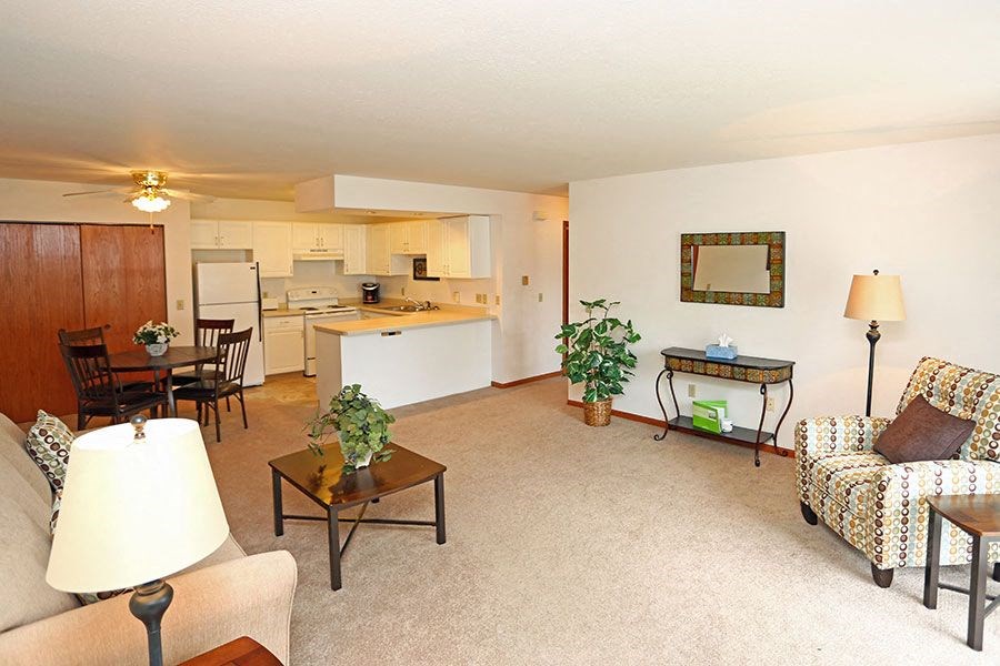 a living room with a kitchen and a table