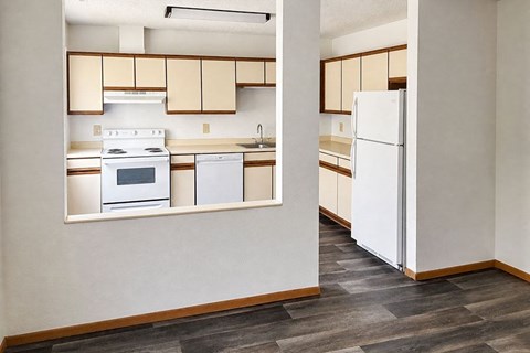 A kitchen with a white refrigerator and white oven.