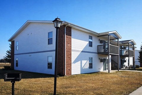 A two-story house with a garage on the first floor and a balcony on the second floor.