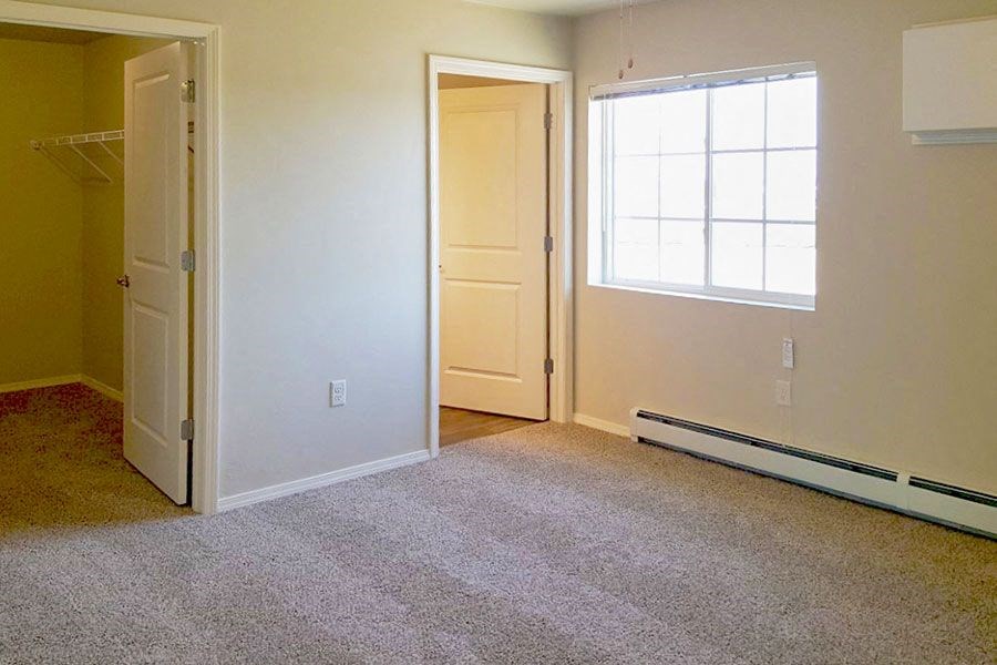 an empty room with a door and a window