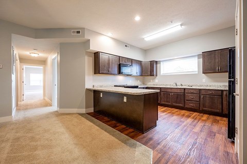 A kitchen with dark wood cabinets and a white countertop.