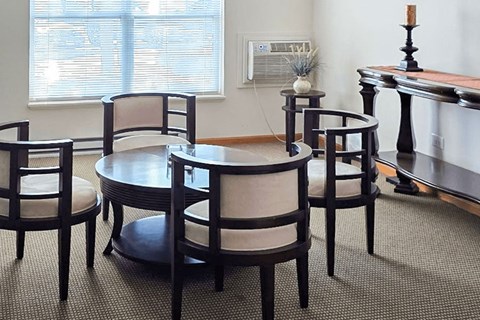 A set of chairs and a table are arranged in a living room.
