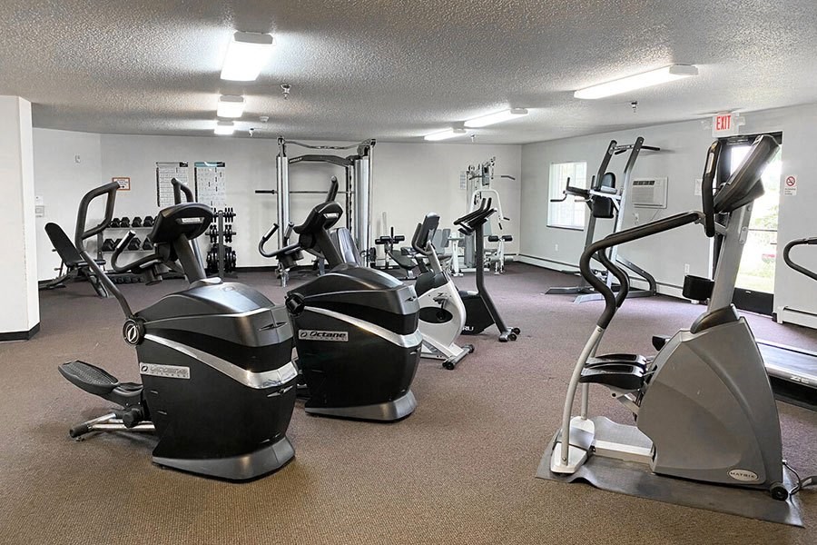 a gym with various exercise equipment in it