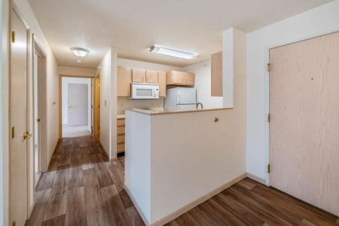 A kitchen area with a microwave, oven, and cabinets.