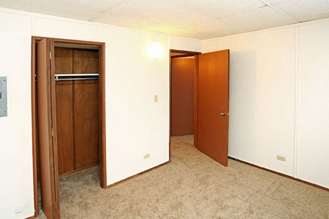 A room with two doors and a carpeted floor.