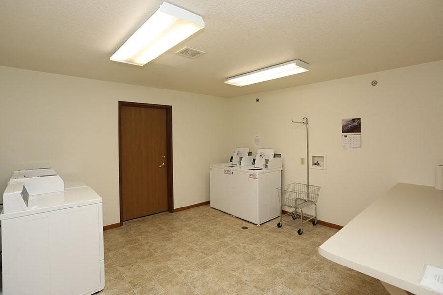 a room with two washes and a dryer in it