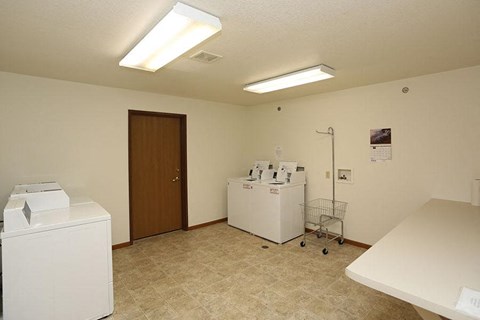 a room with two washes and a dryer in it