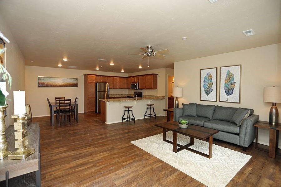 a living room with a couch and a kitchen