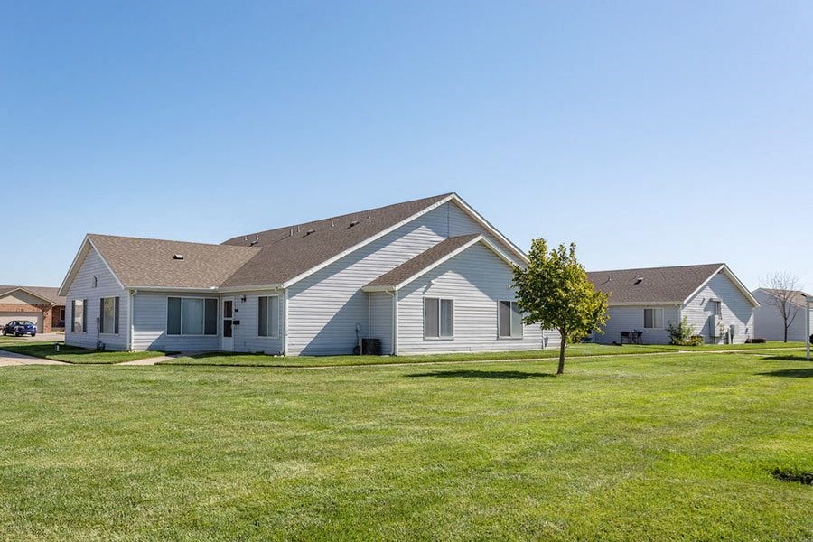 a white house with a yard in front of it