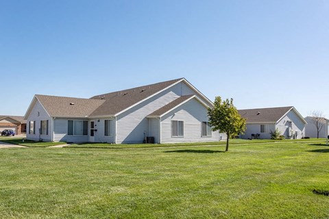 a white house with a yard in front of it