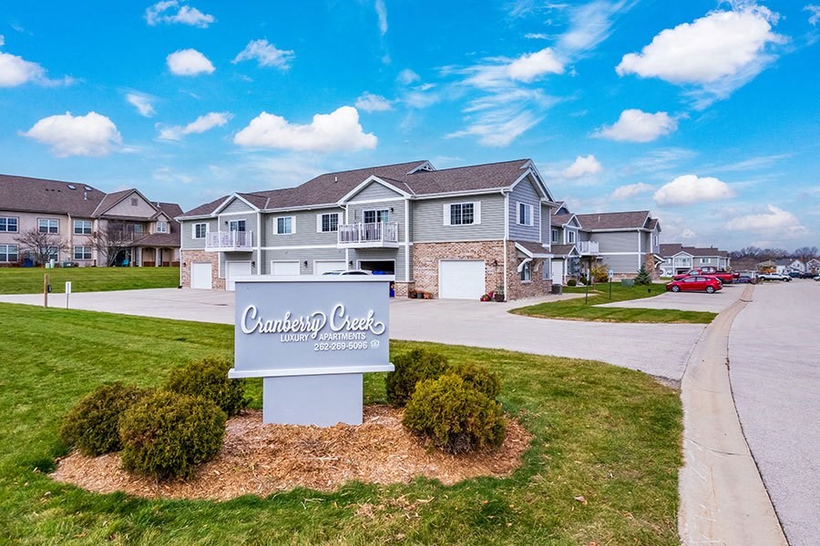 a sign in front of a subdivision with houses