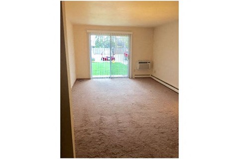 a empty living room with a sliding glass door