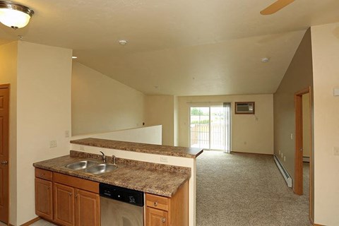 an empty kitchen with a sink and a counter top