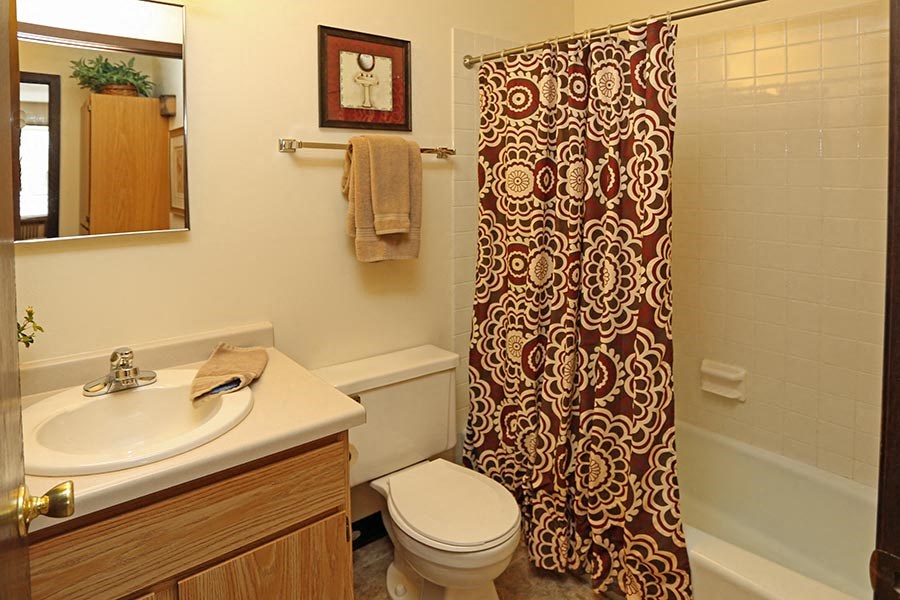 a bathroom with a shower and a sink and a toilet