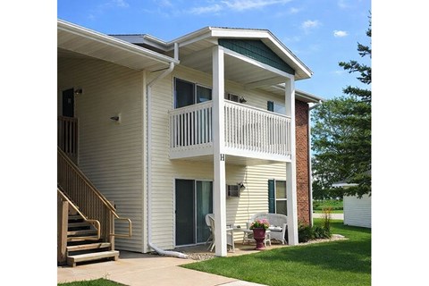 A two-story house with a balcony on the second floor.