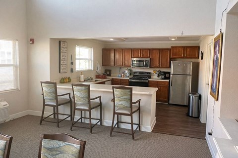 A kitchen with a dining table and chairs.