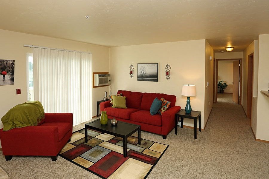 a living room with a red couch and a table