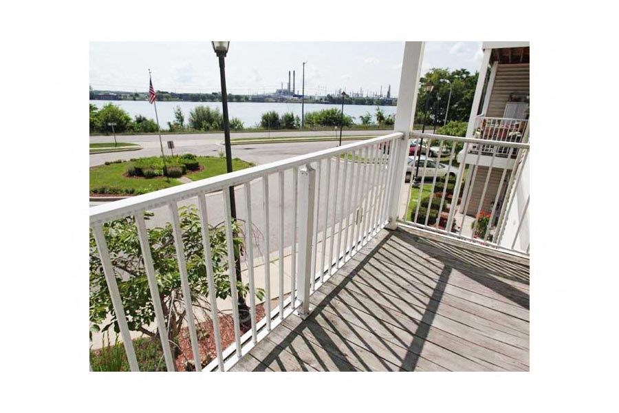 a balcony with a view of a body of water