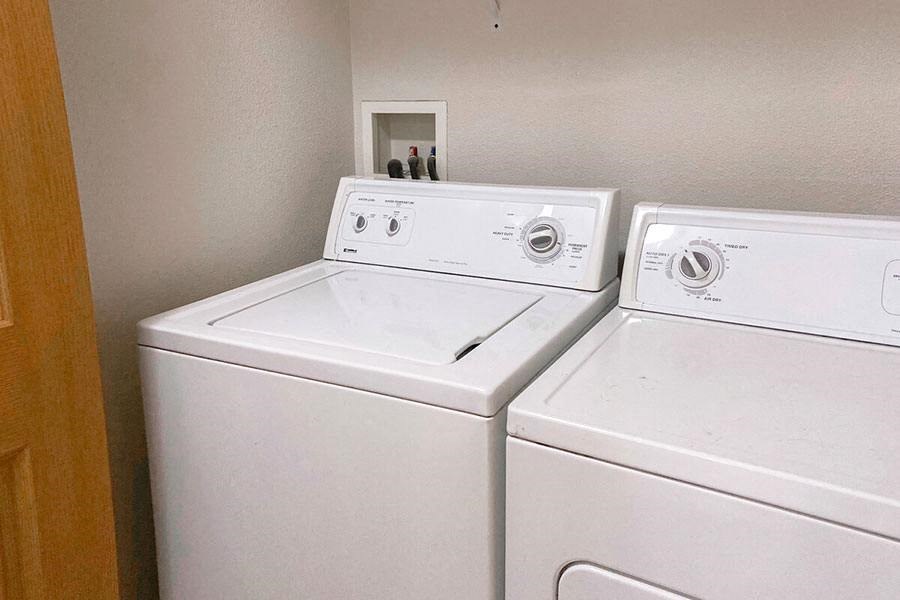 two washing machines are next to each other