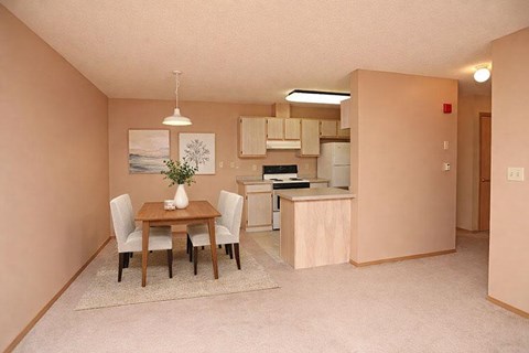 A kitchen with a table and chairs in the middle of the room.