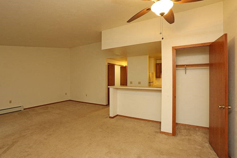 A room with a ceiling fan and a door.