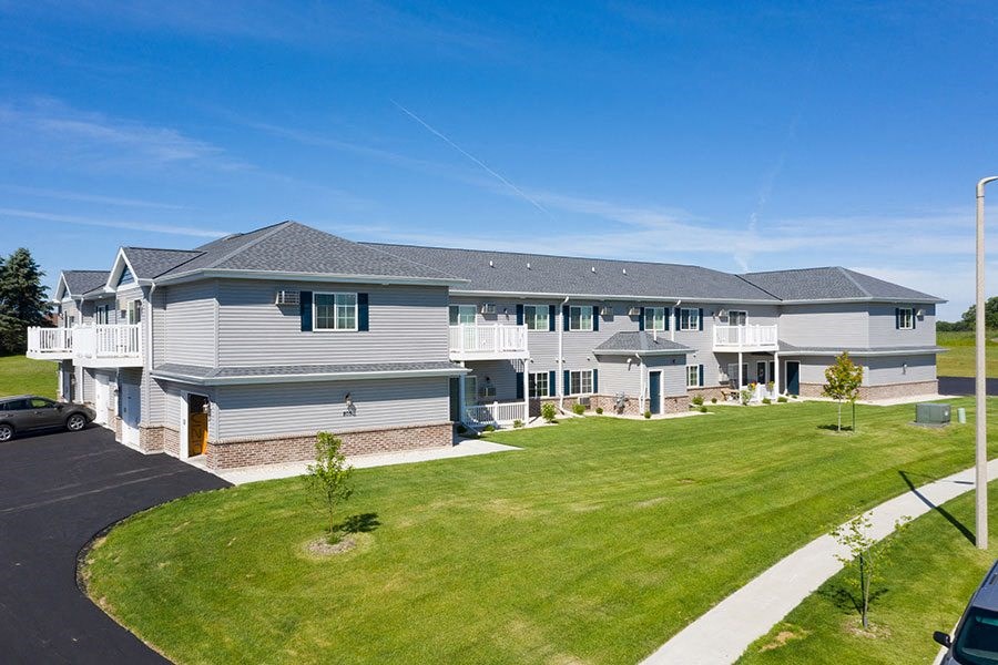 a large white house with a lawn in front of it