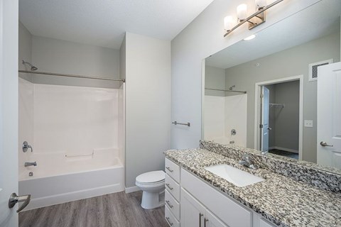 A bathroom with a sink, toilet, and bathtub.