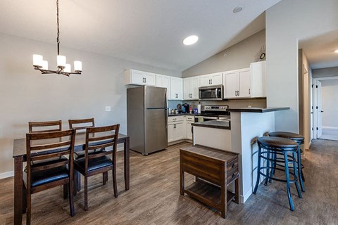 a kitchen and dining room with a table and chairs
