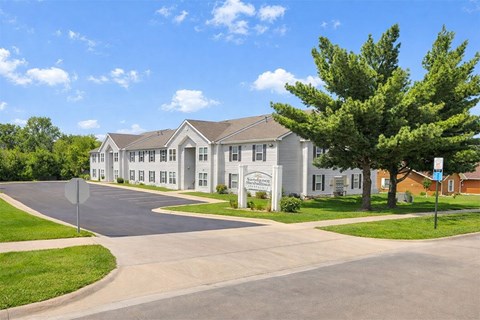 A large building with a driveway in front of it.