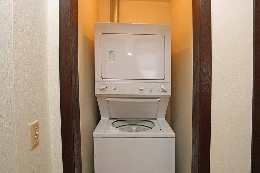 a small bathroom with a toilet and a washing machine