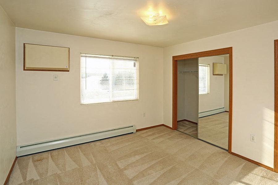 an empty room with a door and a window