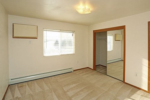 an empty room with a door and a window