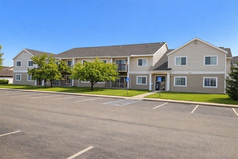 A large building with a parking lot in front of it.