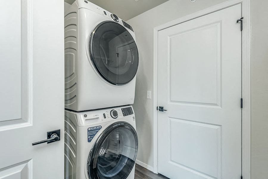 a washer and dryer in a laundry room with a white door