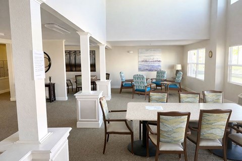 A white dining room with a table and chairs.