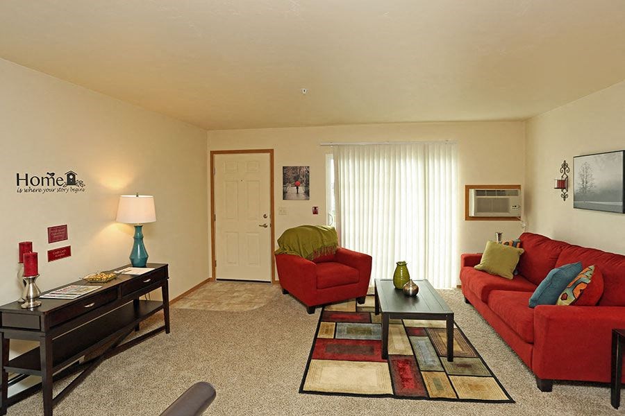 a living room with a red couch and a table