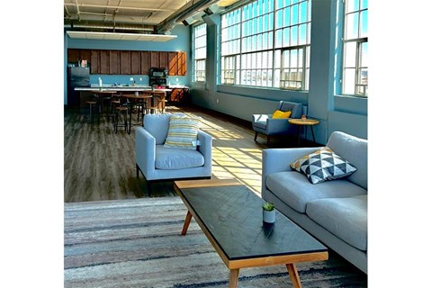 A living room with a couch, chairs, and a coffee table.