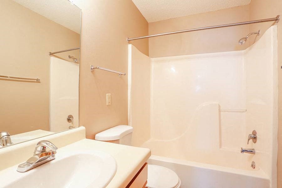 a bathroom with a sink and a shower and a toilet