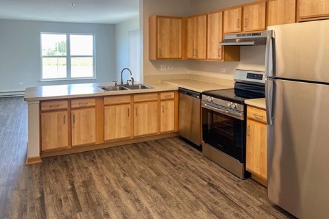 A kitchen with wooden cabinets and stainless steel appliances.