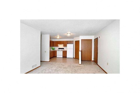 A room with a white ceiling and a brown door.
